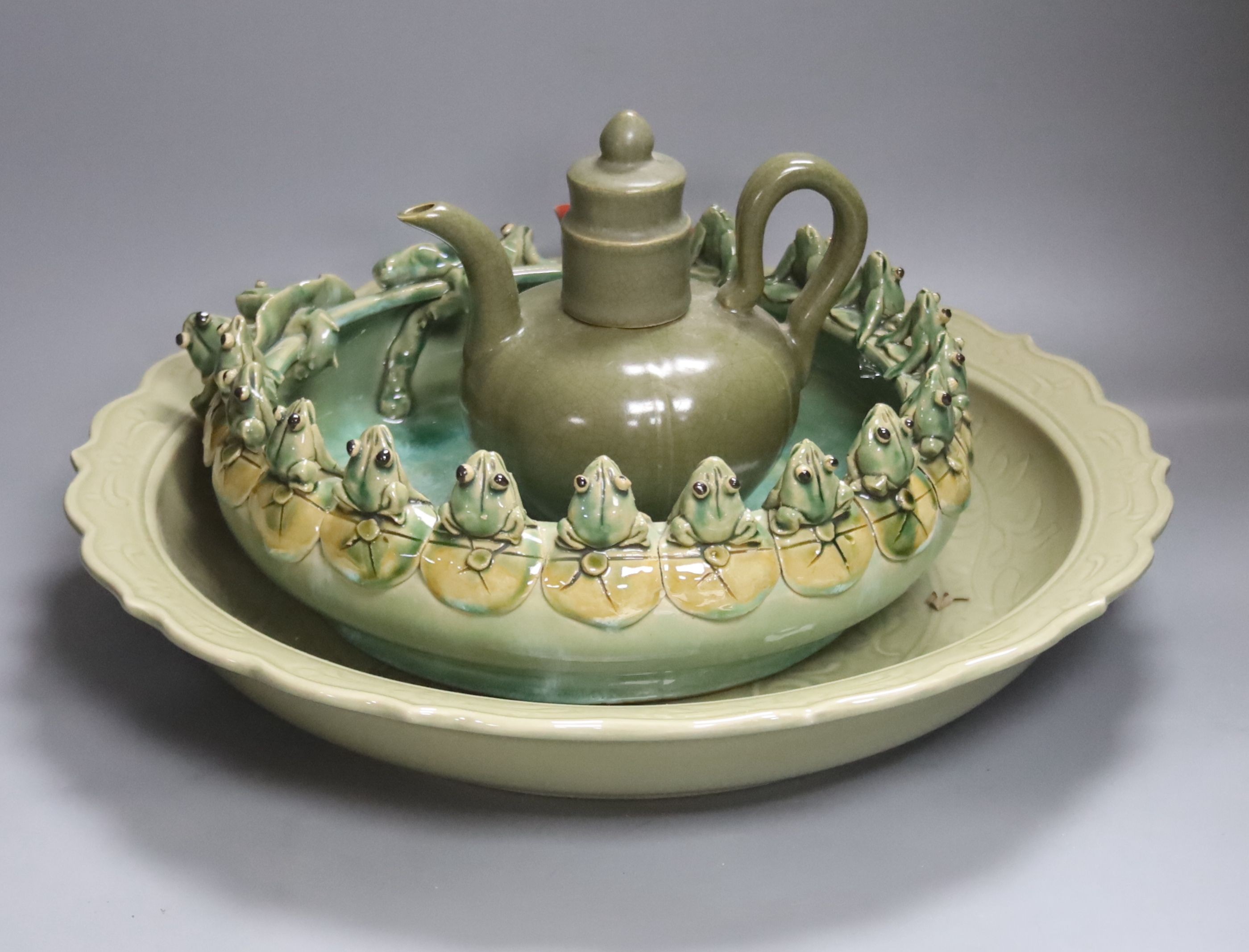 A large Chinese celadon glazed dish, a Chinese green crackle glaze ewer and cover and a 'frog pond' bowl (3)